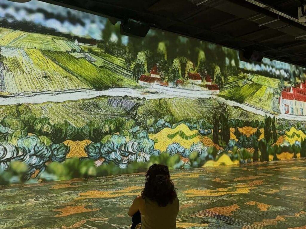 Interior gallery at the Van Gogh Museum with visitors looking at paintings