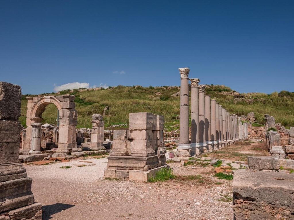 Roman ruins and arched stonework in Venosa with light streaming through.