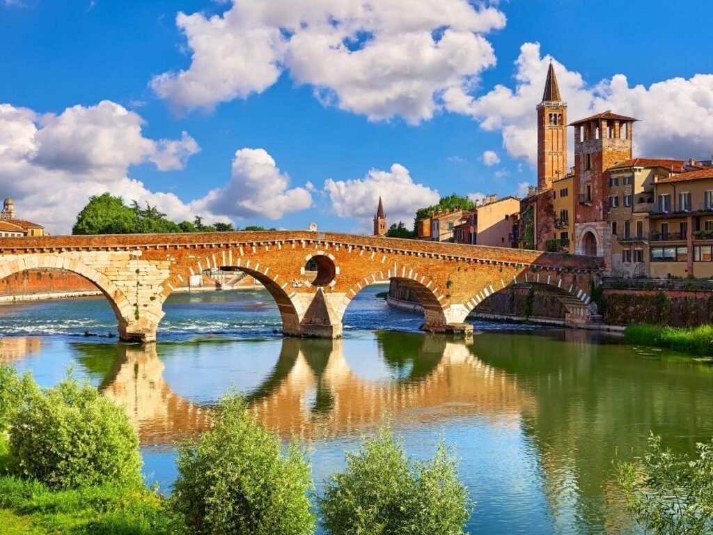 Evening walk along the Adige River in Verona with golden light on the bridges.”