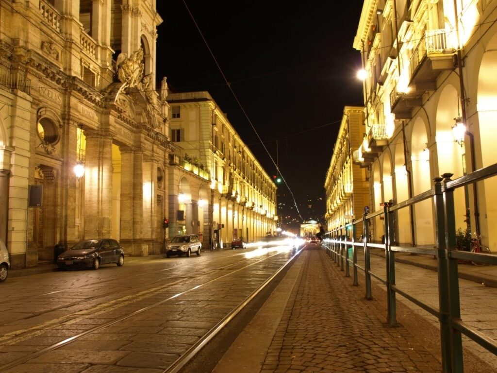Long porticos of Via Po glowing in the late afternoon sun.