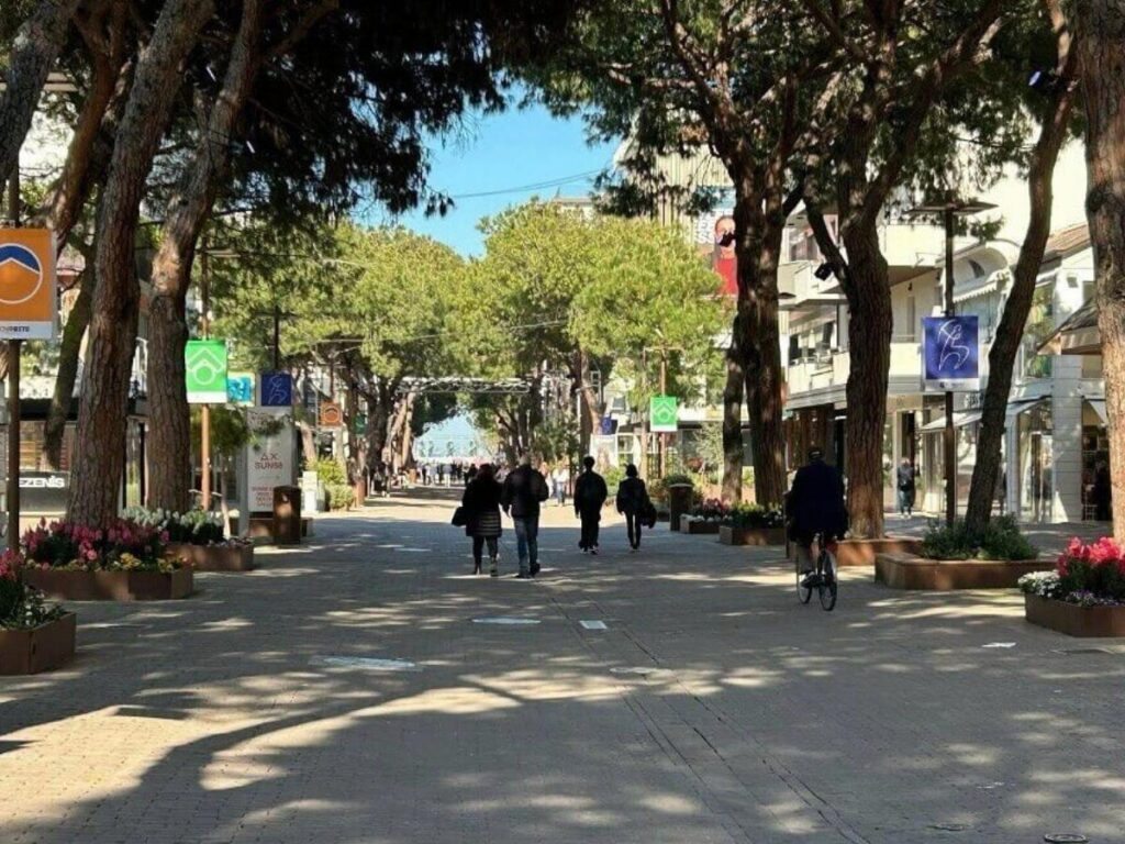 People strolling and shopping along Viale Ceccarini in Riccione in the evening light