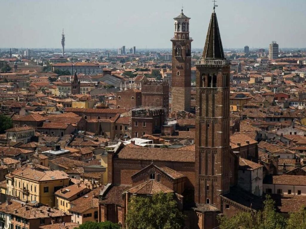 View of Verona’s terracotta rooftops and Adige River from Torre dei Lamberti tower.