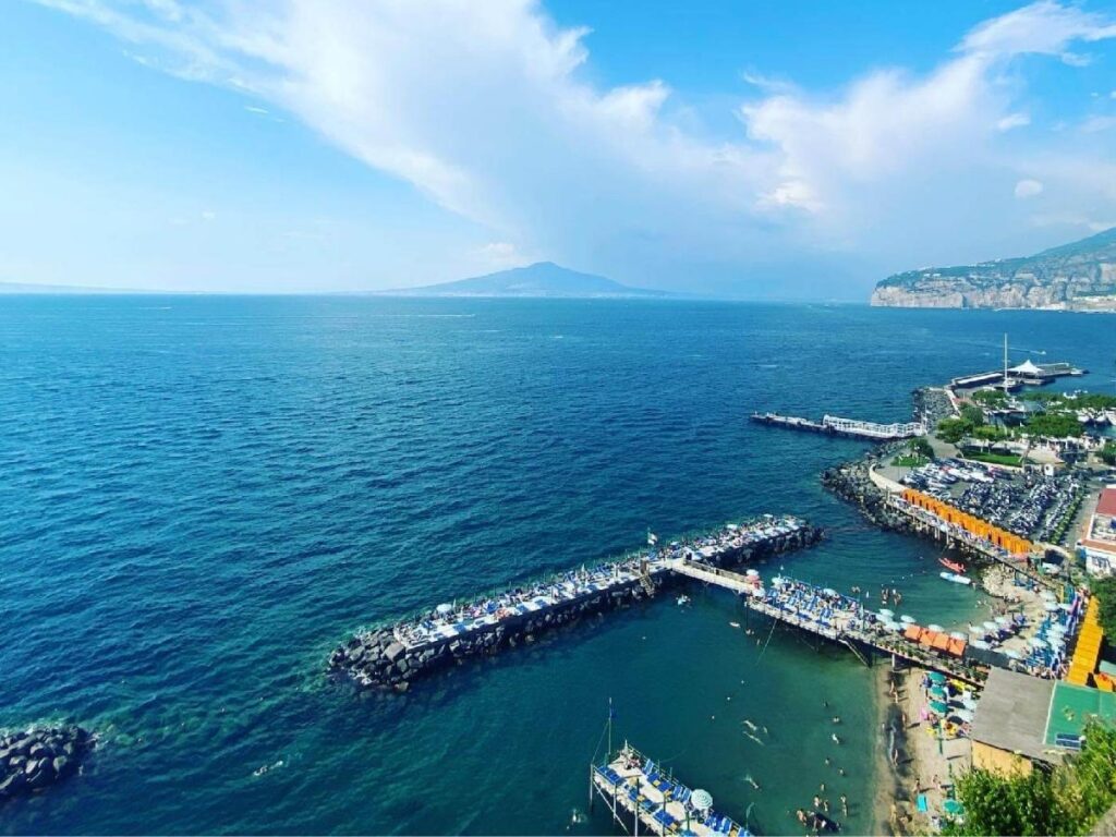Panoramic sunset from Villa Comunale overlooking the Bay of Naples and Mount Vesuvius.