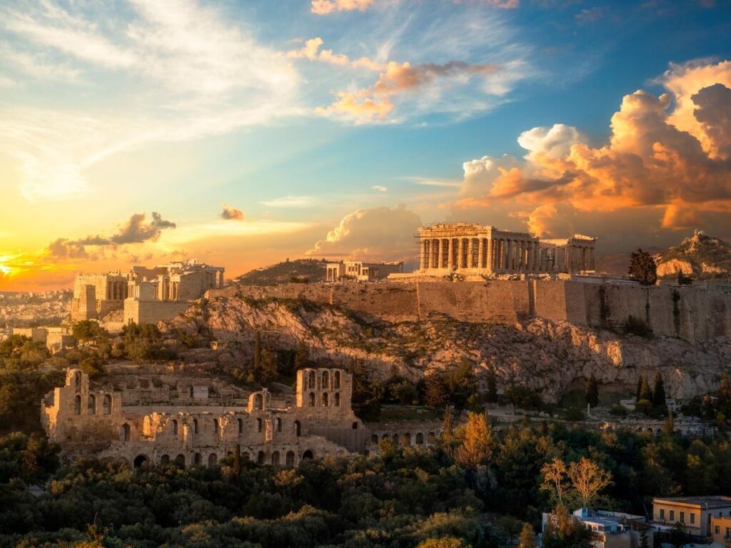 The Parthenon at sunrise, empty paths and soft pink light over a quiet Athens morning.