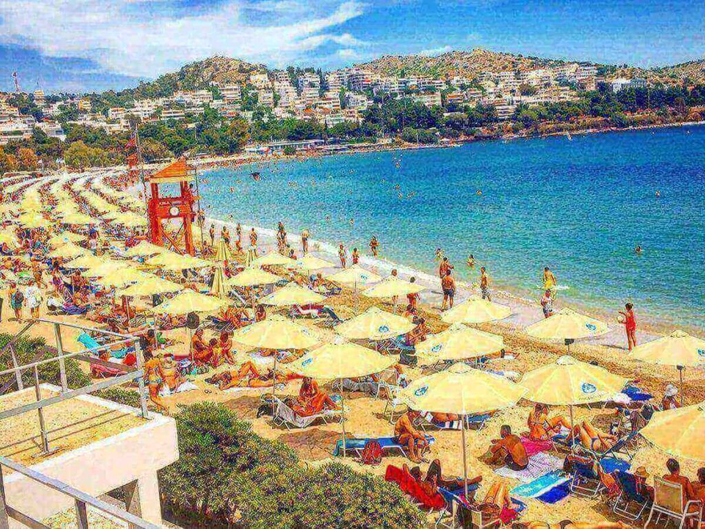 Early morning sunbeds and umbrellas at Akti Vouliagmenis with empty beach