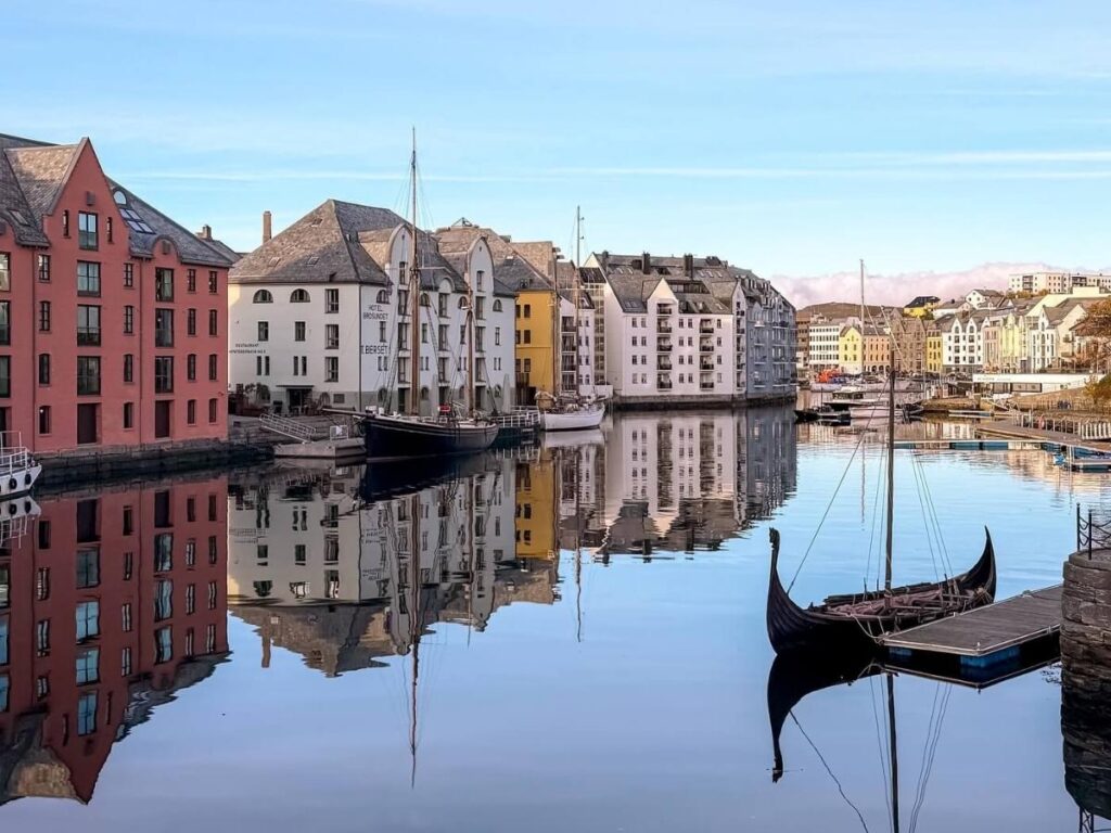 Brosundet waterfront at blue hour with warm lights reflecting on the water.