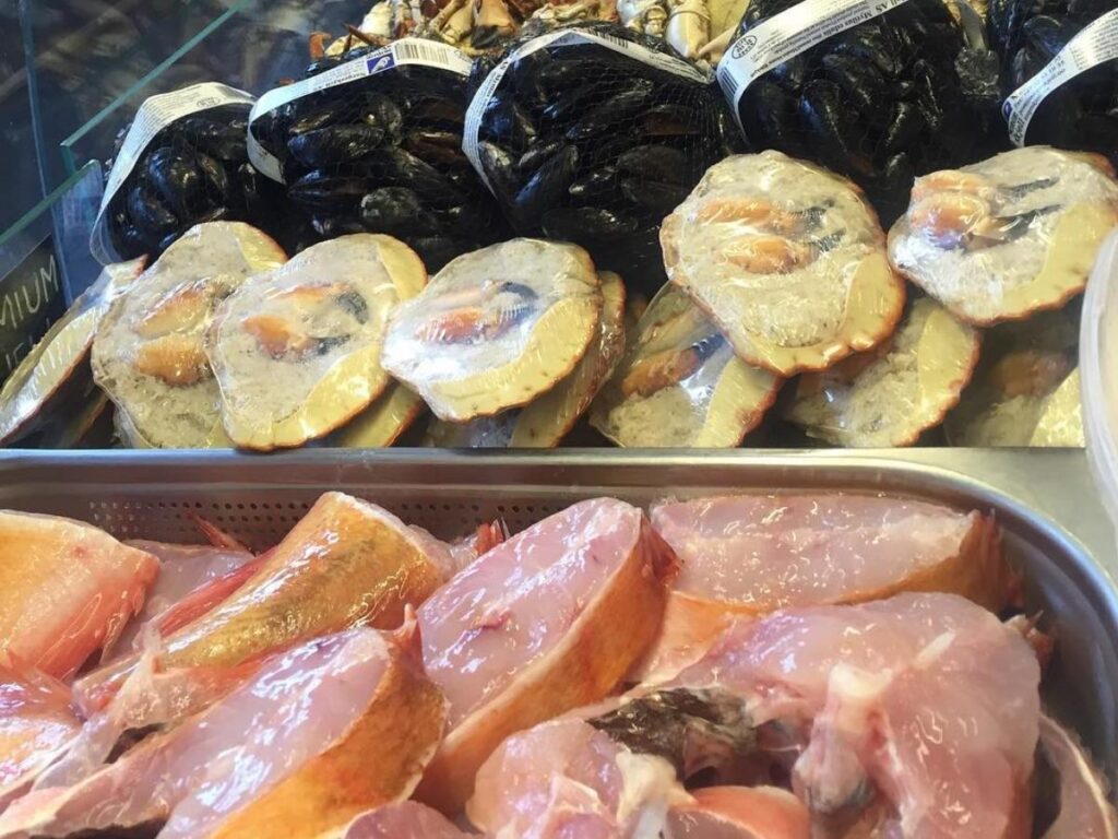 Fresh fish and shellfish on display at Fisketorget by the harbour in Ålesund.