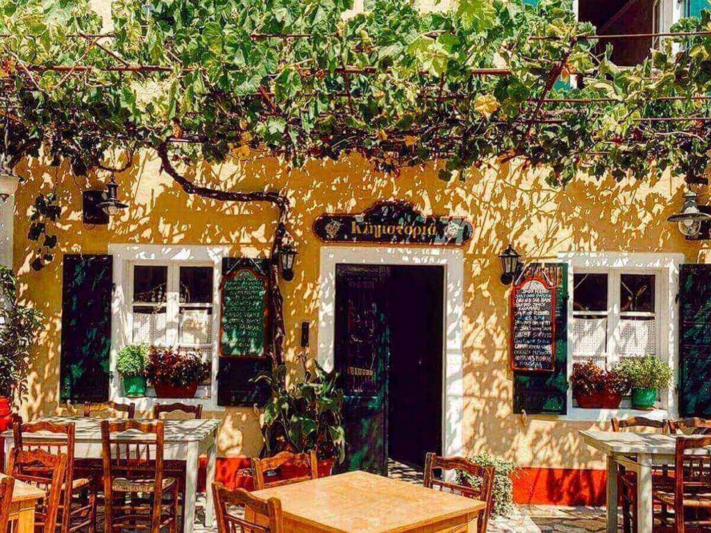 Simple beach taverna at Vrika Beach in Antipaxos with tables overlooking the sea