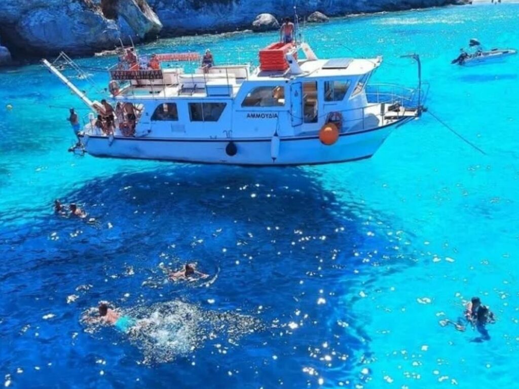 Families and swimmers enjoying the shallow, warm water at Vrika Beach, Antipaxos