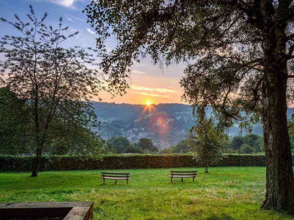 Sweeping sunset view over Bath from Alexandra Park, with rooftops and soft golden light