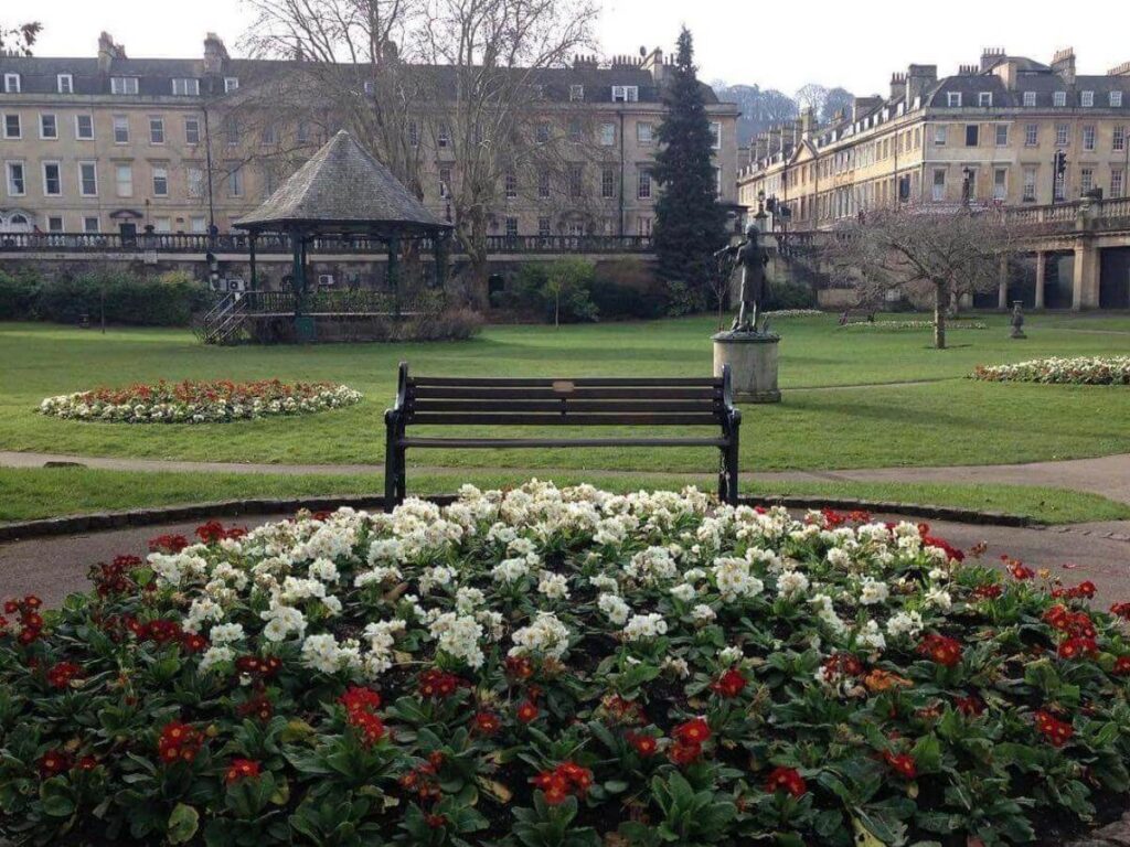 Quiet corner of Parade Gardens with green lawns and trees on a sunny morning