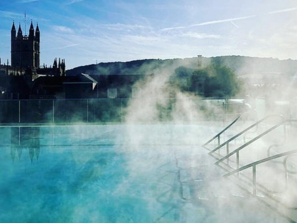 Rooftop thermal pool at Thermae Bath Spa overlooking Bath’s skyline and hills
