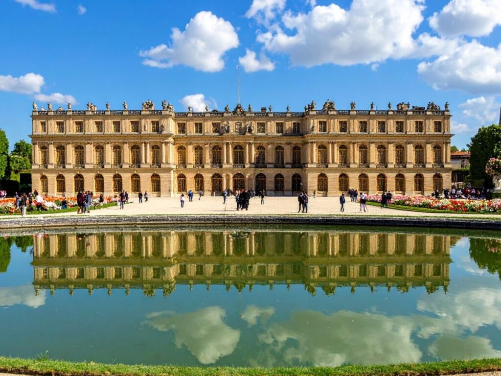 Belvedere Palace with reflecting pool and manicured gardens on a bright day