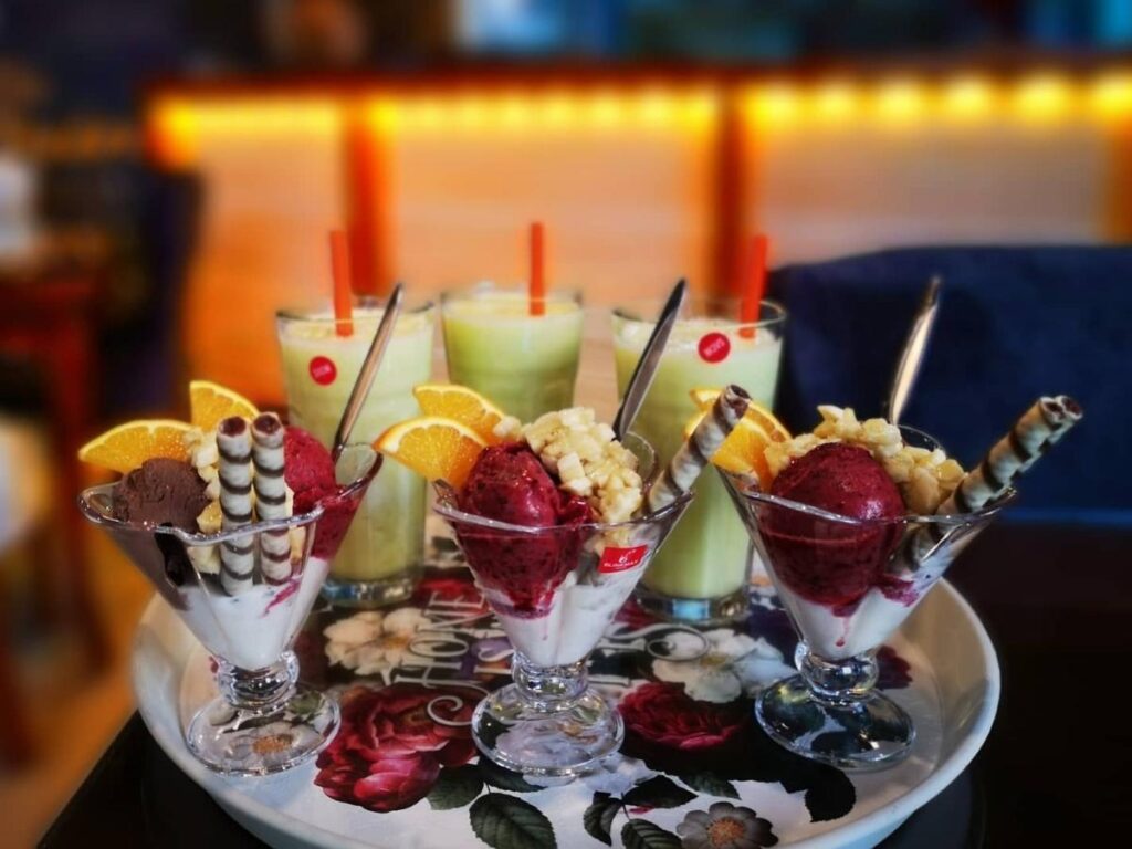 Coffee and smoothie bowl at Café Cantaloupe overlooking the marina in Olhão, Portugal