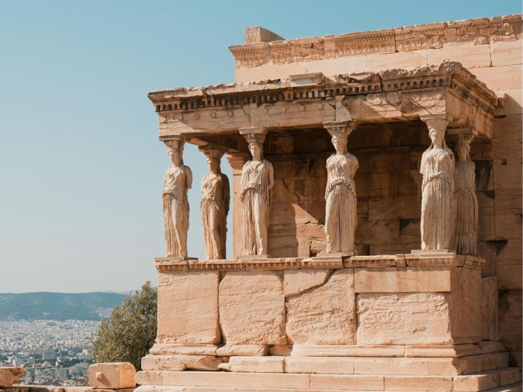 Close-up of the Caryatids on the Erechtheion, showing sculpted detail and the texture of ancient marble.