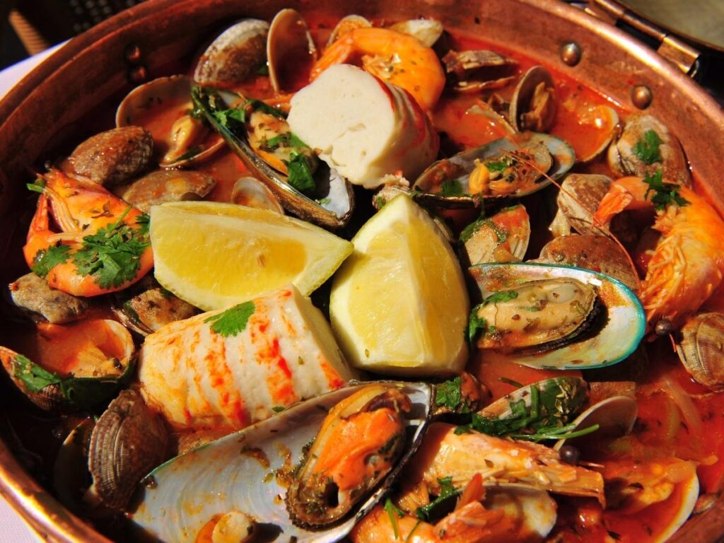 Traditional cataplana de marisco seafood stew served in a copper pot at Terra i Mar, Olhão, Portugal