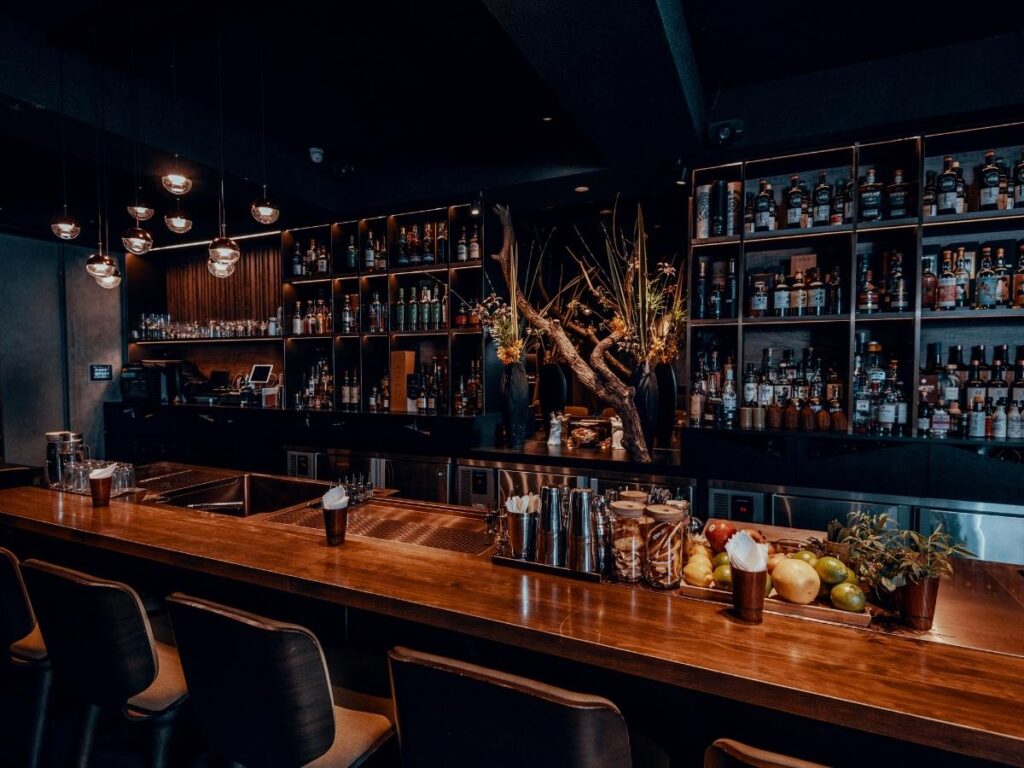 Aperol spritz on a table at Little Star Bar with Cavtat harbour glowing at sunset and boats silhouetted in golden light