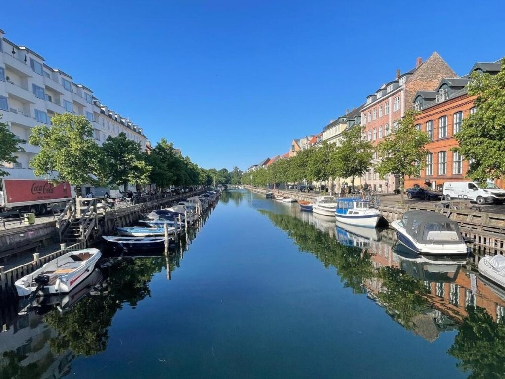 Houseboats and street art along the canals of Christianshavn and Freetown Christiania in Copenhagen.