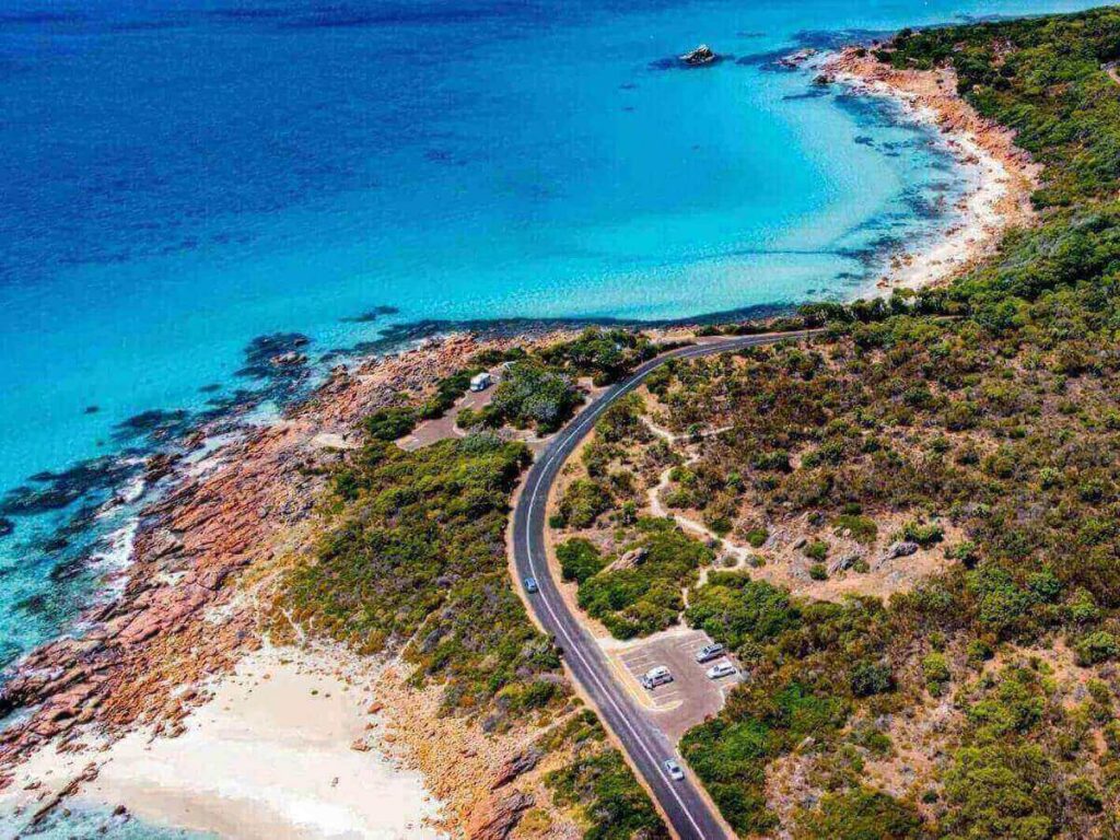 Coastal road of the Athens Riviera with cliffs on one side and a blue sea on the other