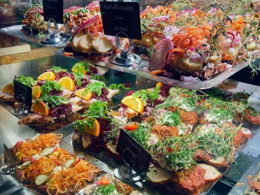 Traditional Danish smørrebrød and pastries served with coffee in Copenhagen.