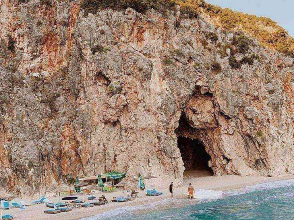 Small pebbled cove near Dhërmi with clear water and cliffs framing the beach