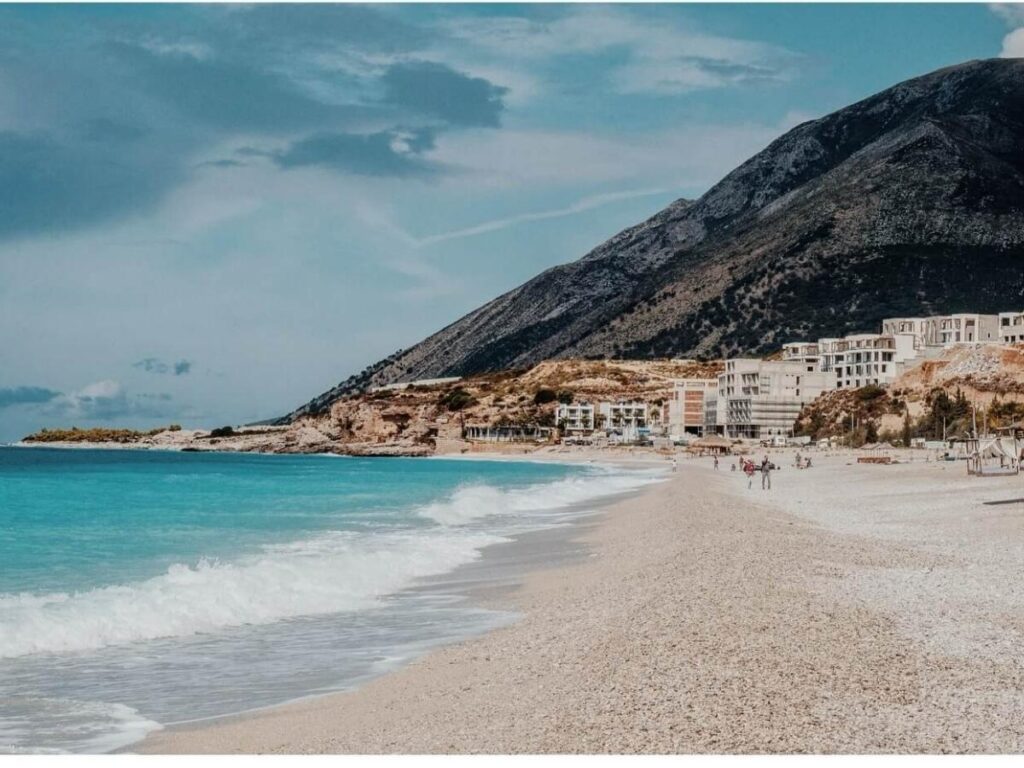 Turquoise water and small rocky coves at Drymades Beach near Dhërmi