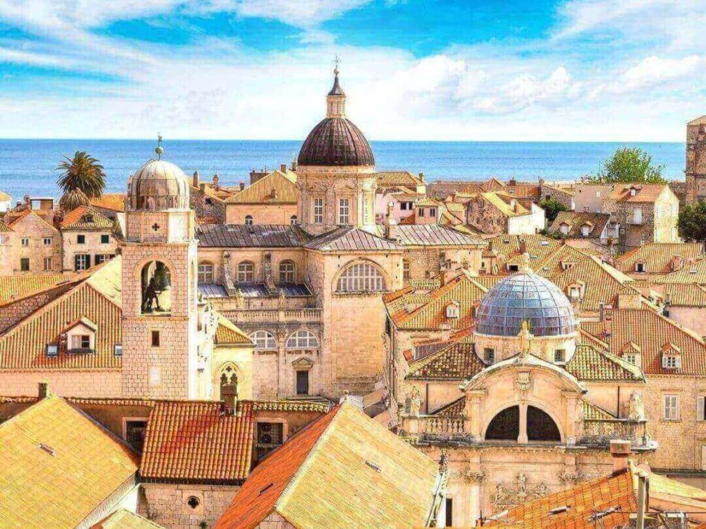 Walkers on the Dubrovnik city walls with the Adriatic Sea in the background