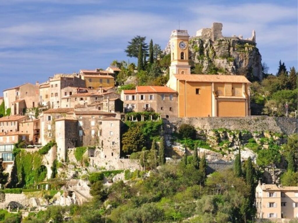 “Sea view framed through a stone archway in Èze’s lower village lanes