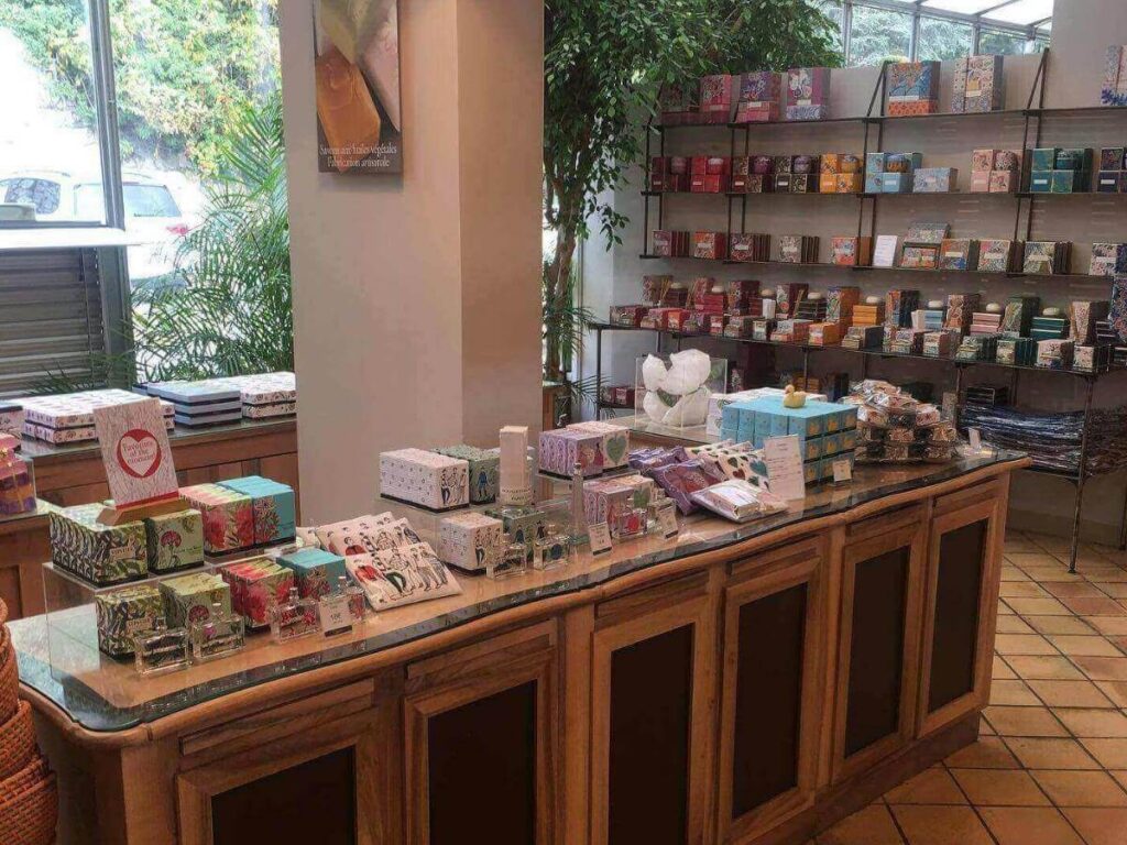 Perfume bottles displayed inside a fragrance shop in Èze during an afternoon visit