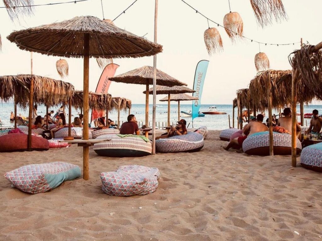 Family playing on Varkiza’s shallow sandy beach at low tide