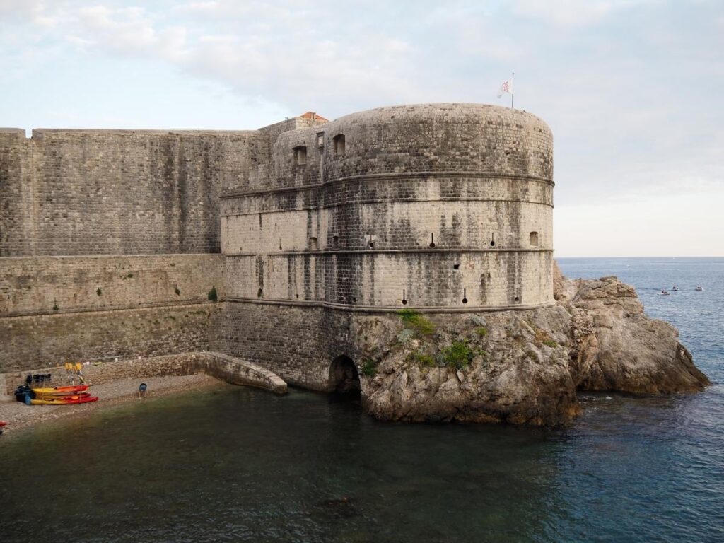 Fort Lovrijenac perched on a cliff with the Old Town skyline in the distance
