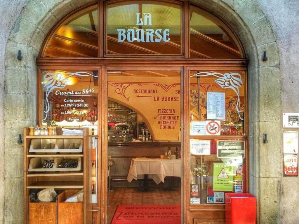 Pastries and coffee on an outdoor table at a café in Carouge, Geneva