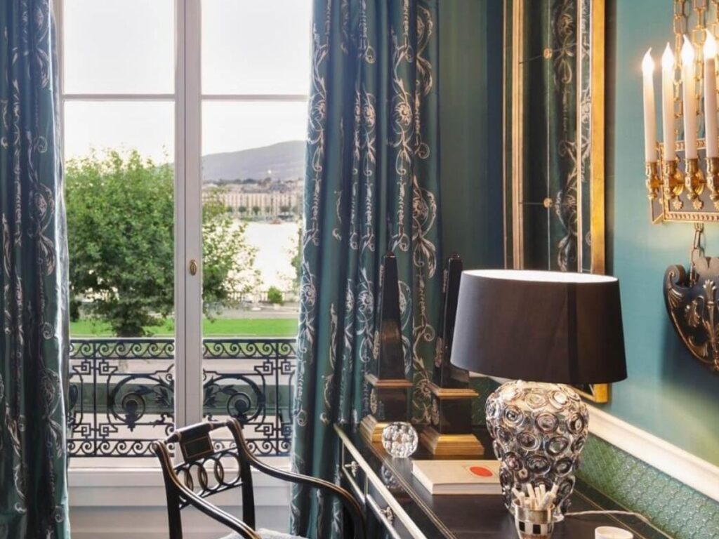 View of Lake Geneva and the Jet d’Eau from a hotel balcony in a luxury waterfront hote