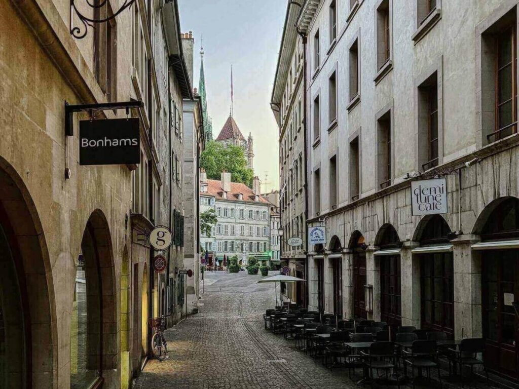 Narrow cobblestone alley and stone houses in Geneva’s Old Town