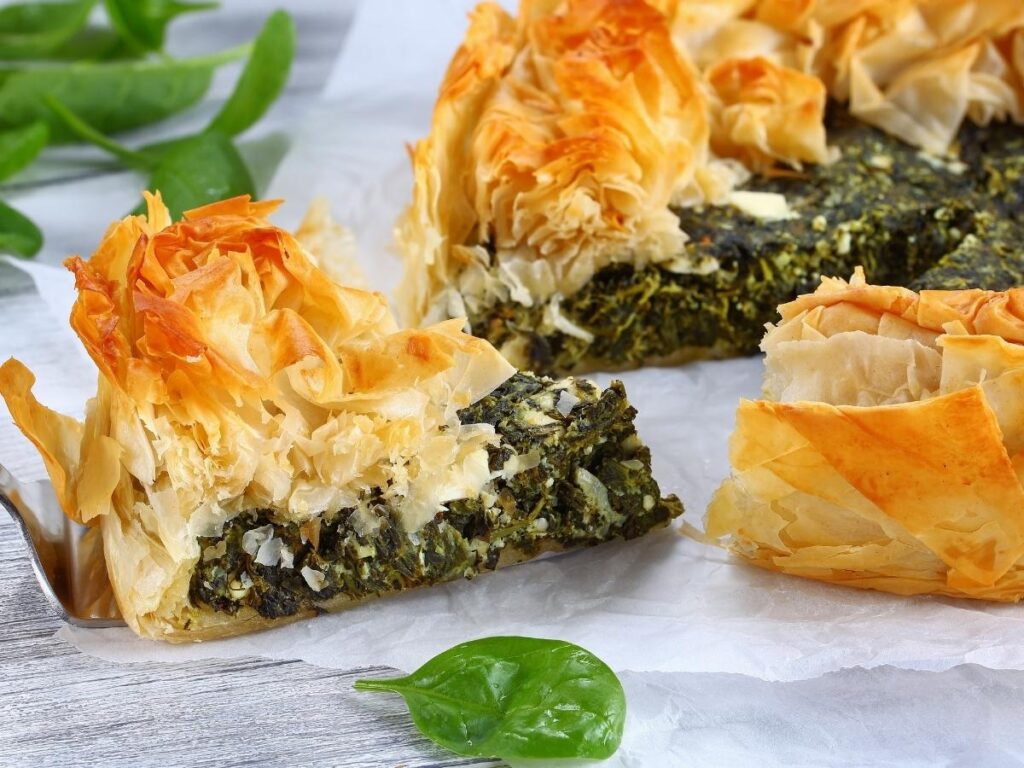 Flaky spinach pie and cold freddo espresso served at a café in Plaka, Athens.