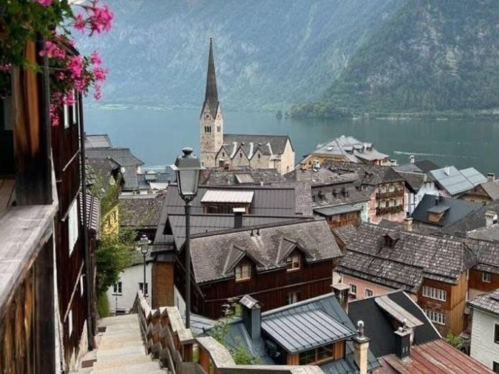 Scenic lakeside view of Hallstatt village with mountains behind.