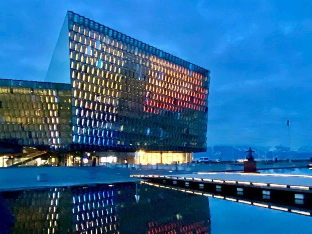Harpa Concert Hall in Reykjavík with its geometric glass façade reflecting the sea