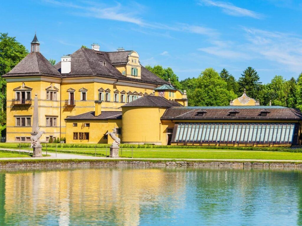 Visitors laughing as water sprays from one of Hellbrunn’s trick fountains