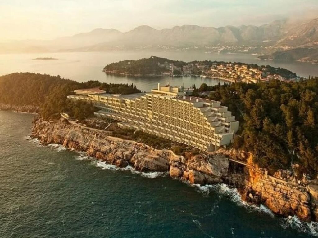 Panoramic view from a balcony at Hotel Croatia Cavtat overlooking the Adriatic Sea and pine-covered coastline
