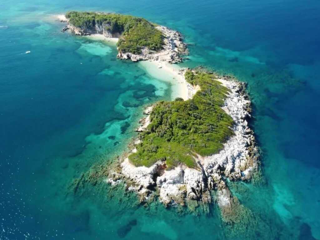 Ksamil islands and shallow turquoise water seen from above with small boats near the shore