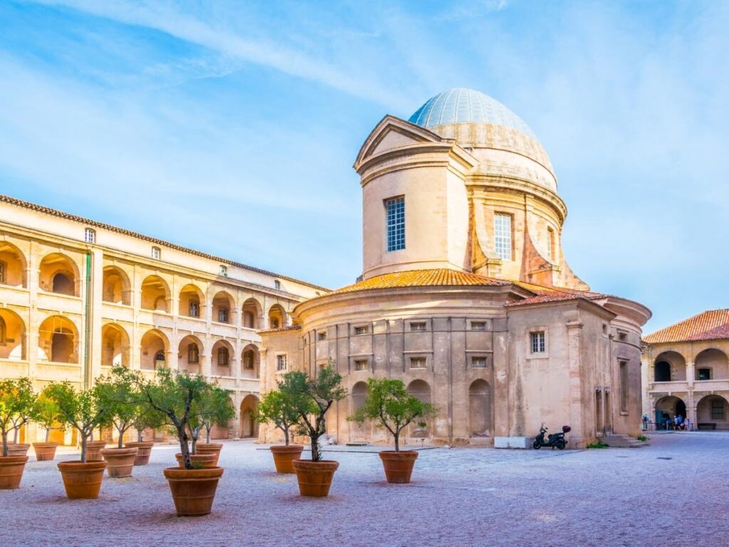 Calm stone courtyard of La Vieille Charité in Le Panier with arches and soft daylight