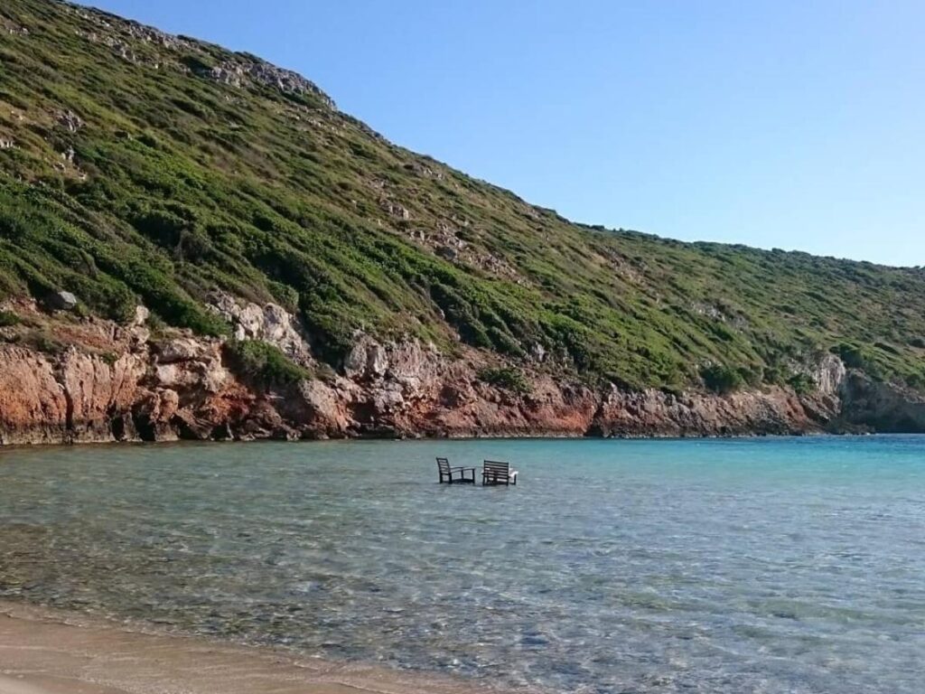 Livadaki cove on Folegandros — pebbled shore and calm turquoise water with rocky backdrop
