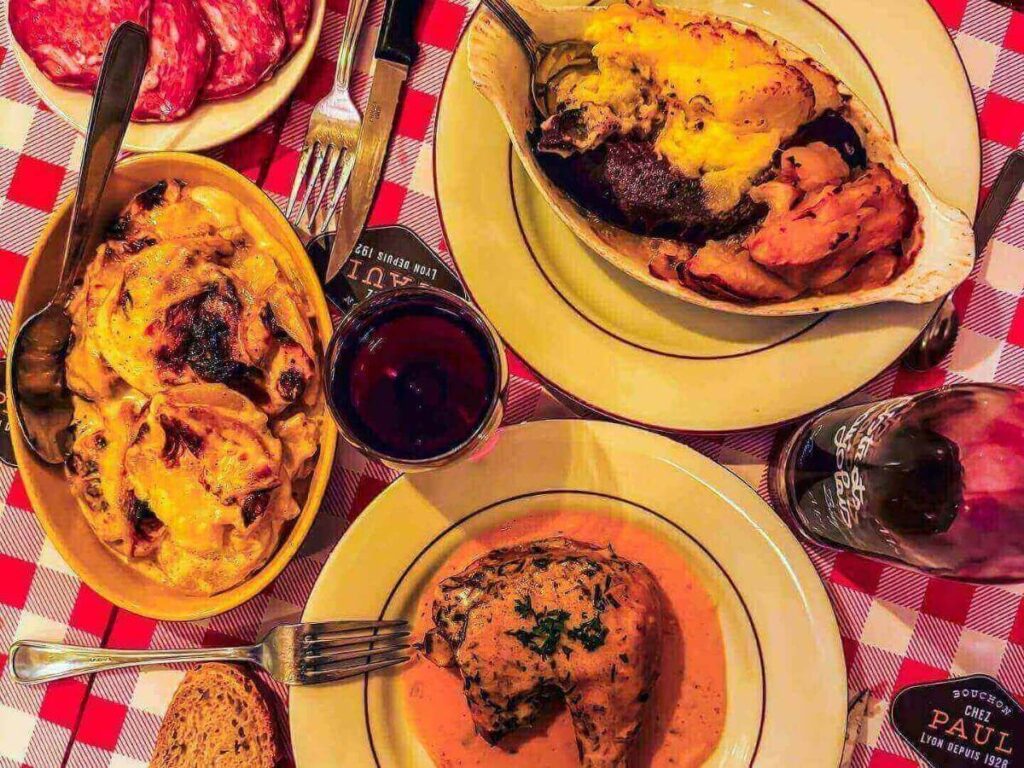 Traditional Lyonnaise dishes including quenelles and Lyonnaise salad served at a bouchon.