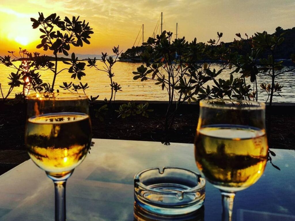 Glass of chilled white wine from Pelješac on a table overlooking Mljet’s harbour