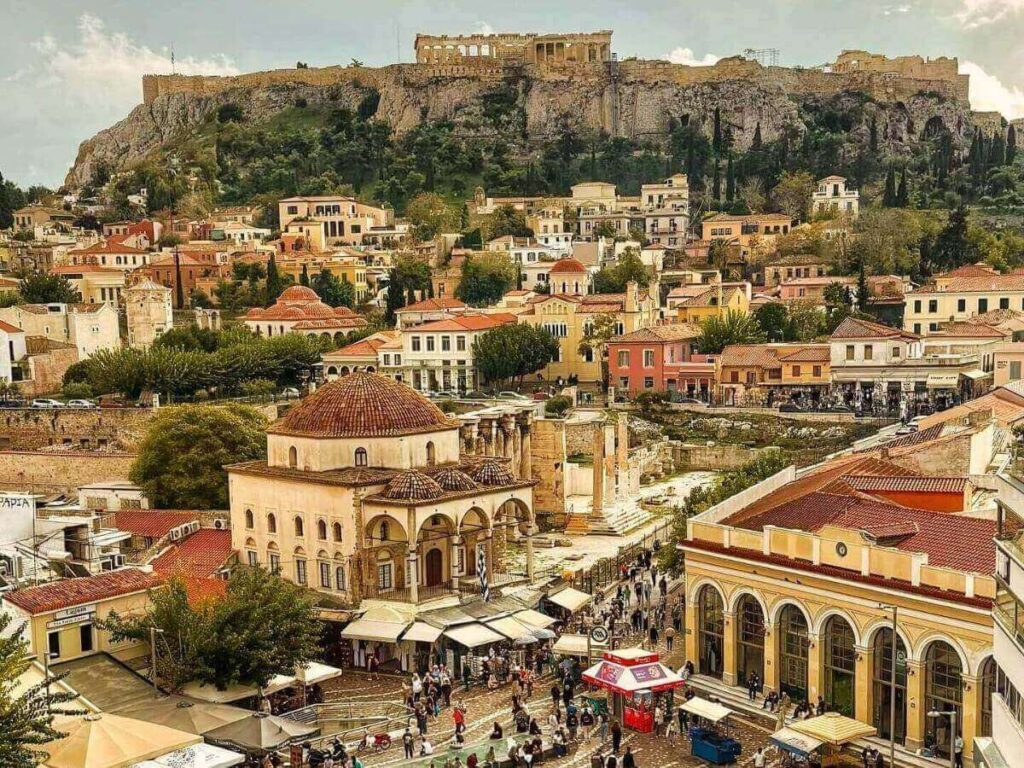 Bustling Monastiraki Market in Athens filled with spices, antiques, and rooftop views of the Acropolis.