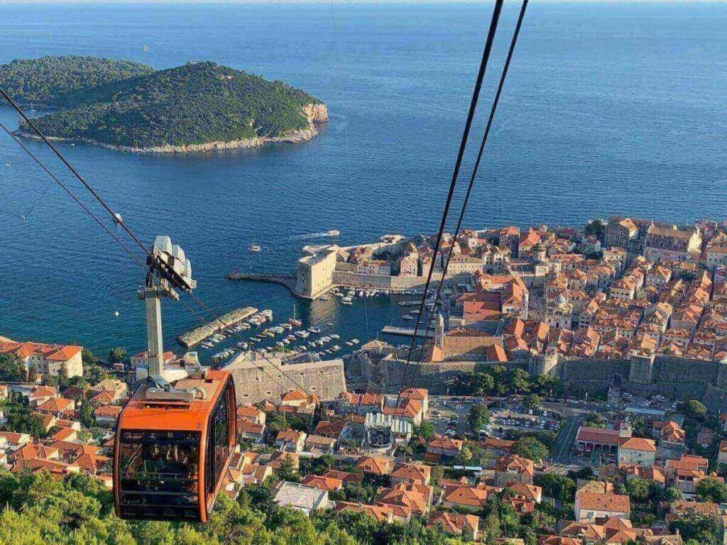 Cable car cabin ascending Mount Srđ with panoramic view of Dubrovnik below