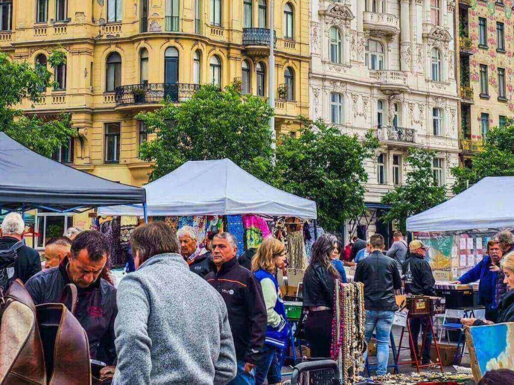 Colourful food stalls and shoppers at Naschmarkt open-air market in Vienna