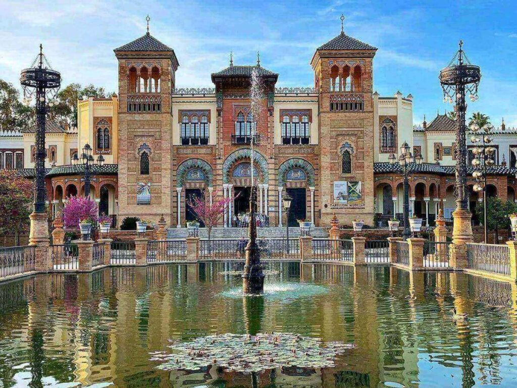 Shady tiled bench and palm trees in Parque de María Luisa, Seville
