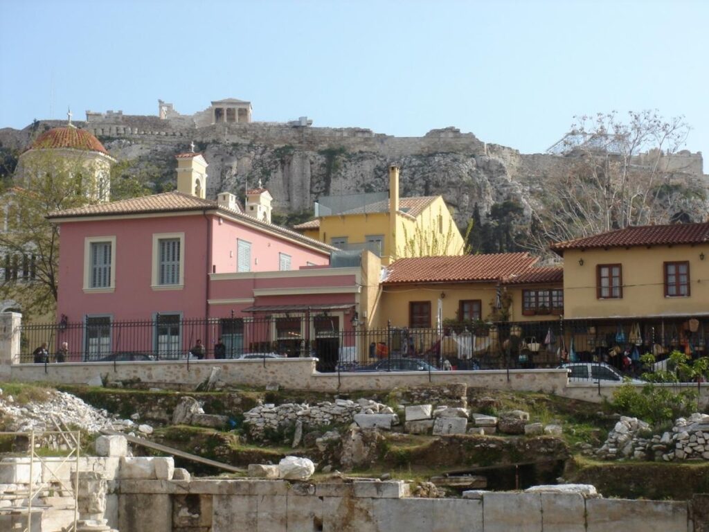A narrow Plaka lane lined with bougainvillea, whitewashed houses and a distant glimpse of the Acropolis above