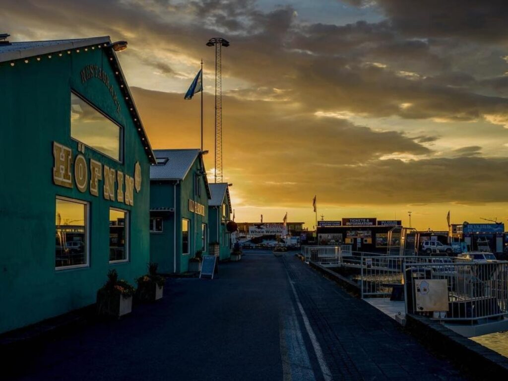 Reykjavík harbour at night with reflections on the water and soft street lighting